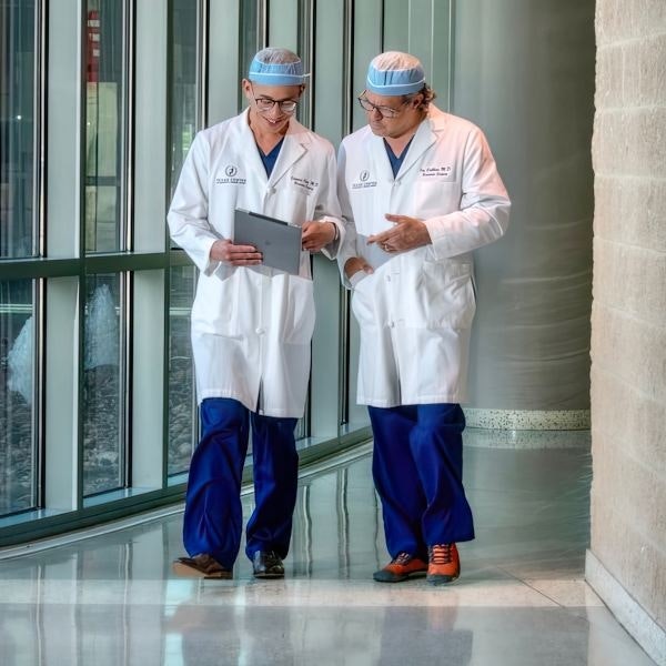 Drs. Cribbins and Chen talking through different procedures while walking