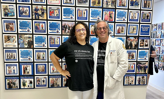 Dr. with patient in front of testimonial wall