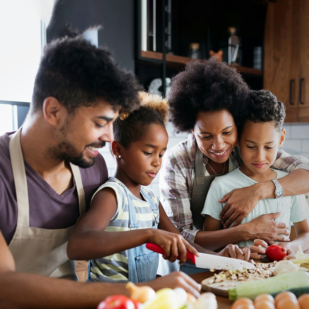 Parents cooking healthy meal with their boy and girl