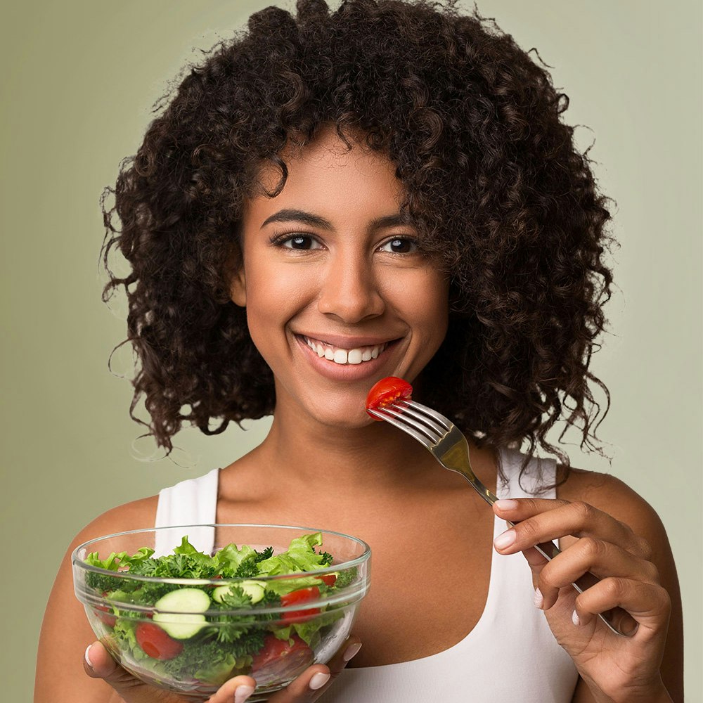 Woman eating salad after nutrition counseling