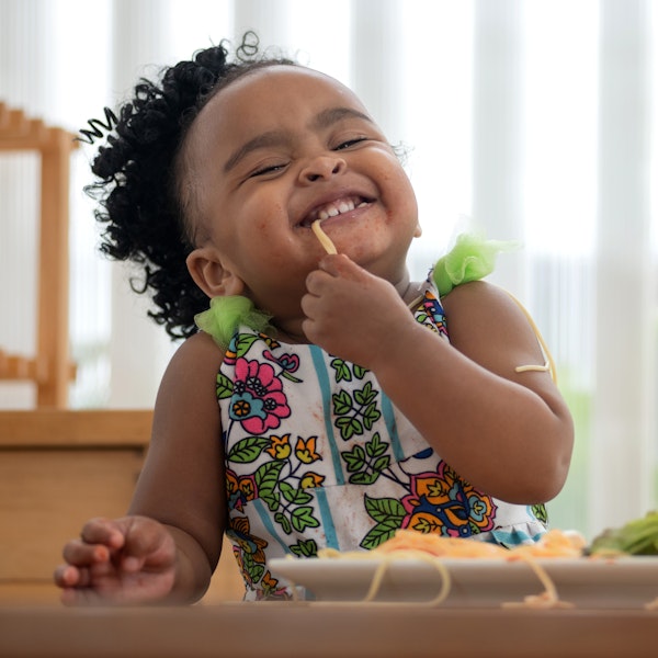 Baby eating and smiling