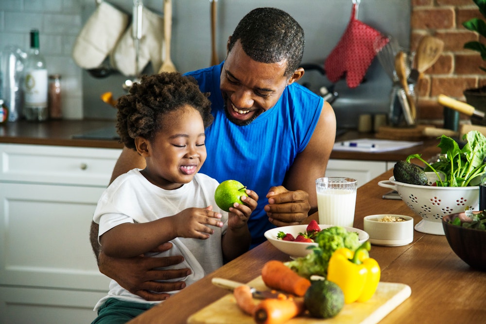 Man and daughter making a snack