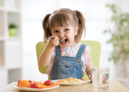 Young girl eating a salad