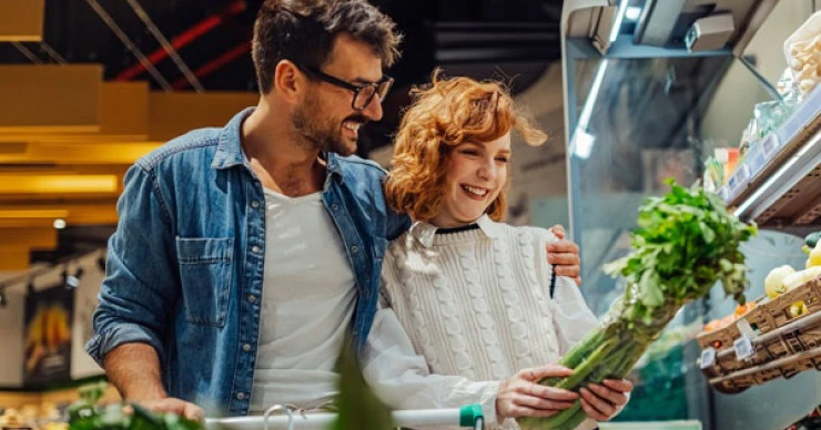 Couple grocery shopping together in a supermarket