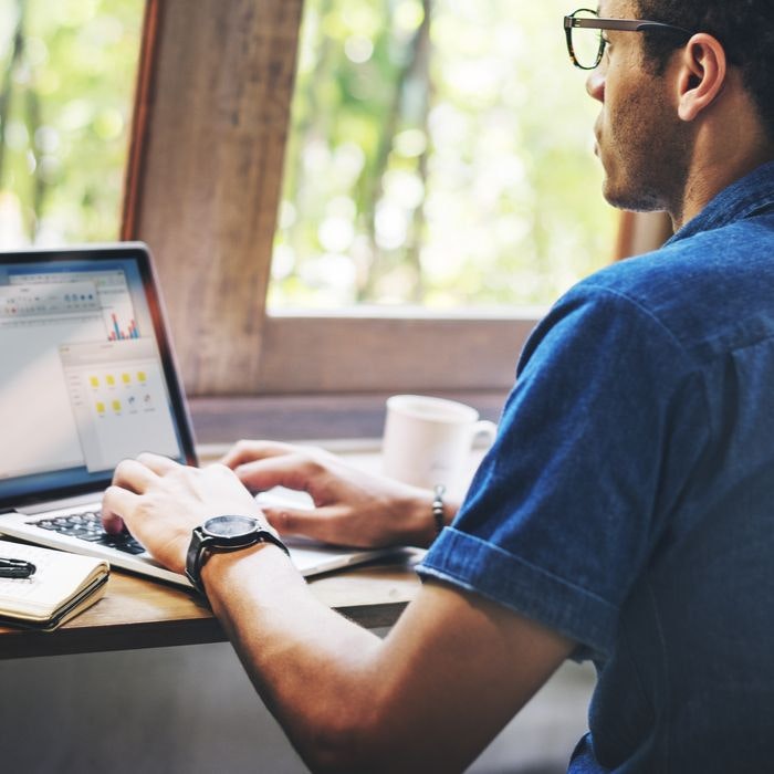 man typing at computer