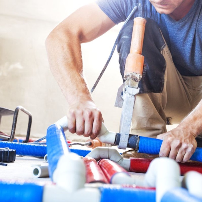man using a power saw