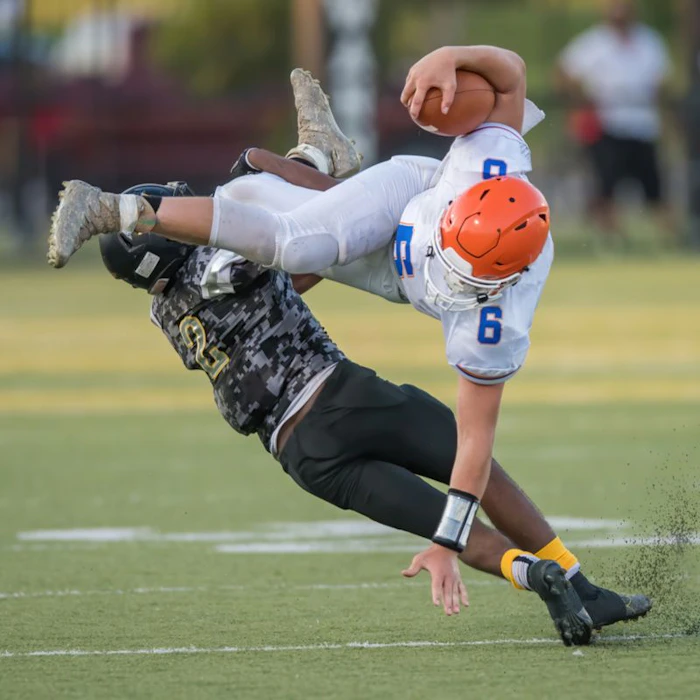 football player getting tackled