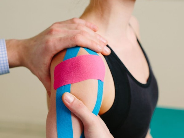 Doctor treating patient with injured shoulder