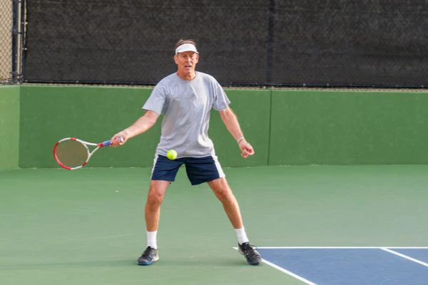 man plays tennis