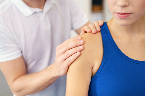 a woman receiving physical therapy for her shoulder