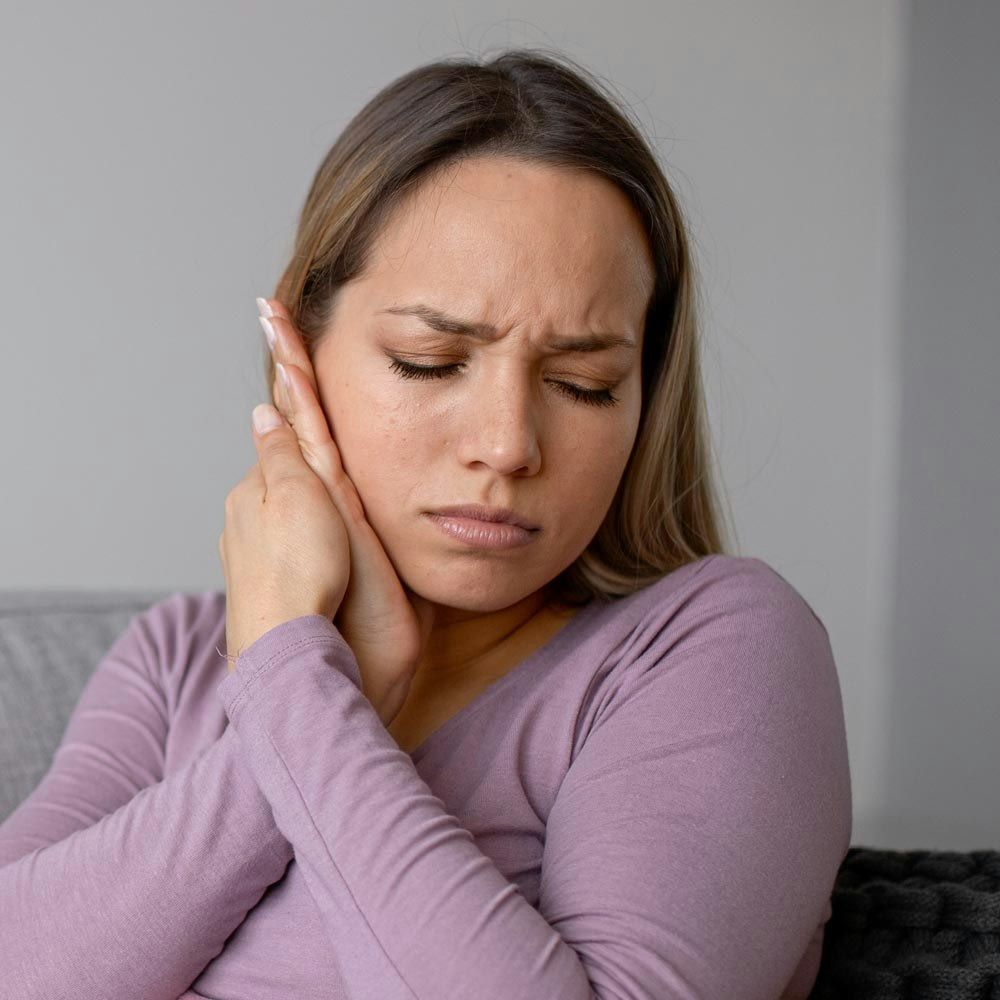 Woman holding jaw in pain