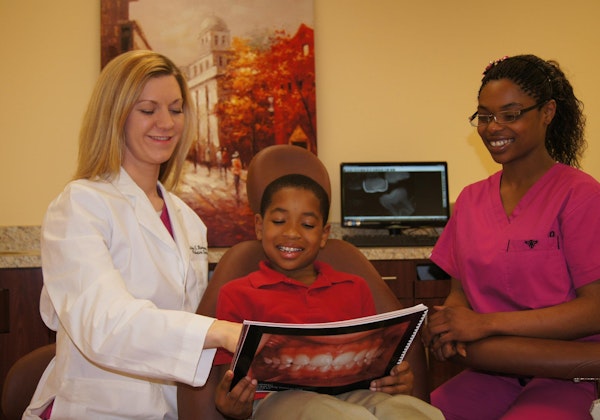 Dr. Ashley Ramsey with patient and hygienist