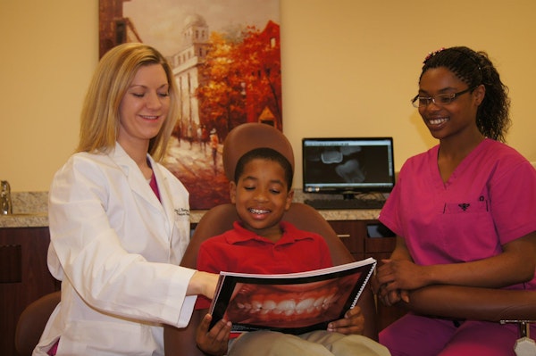 Dr. Ashley Ramsey with patient and hygienist