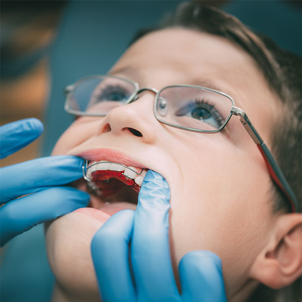 Young boy getting his retainer check