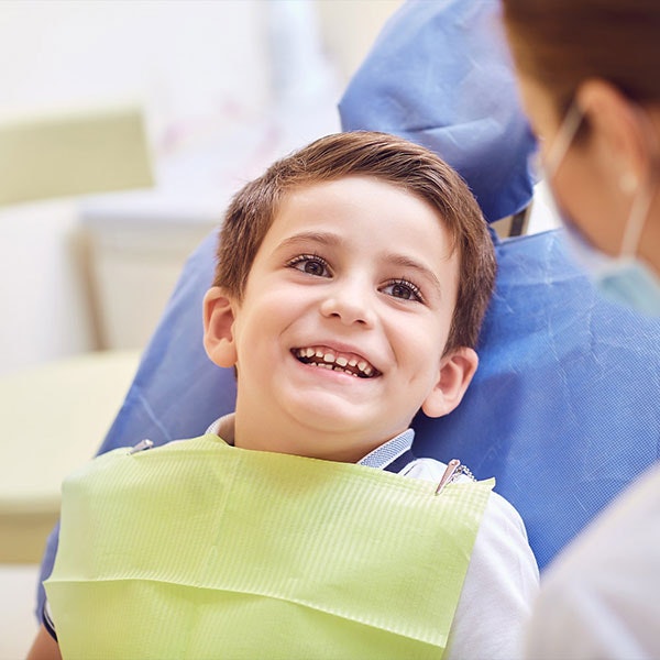 Young boy smiling at the dentist