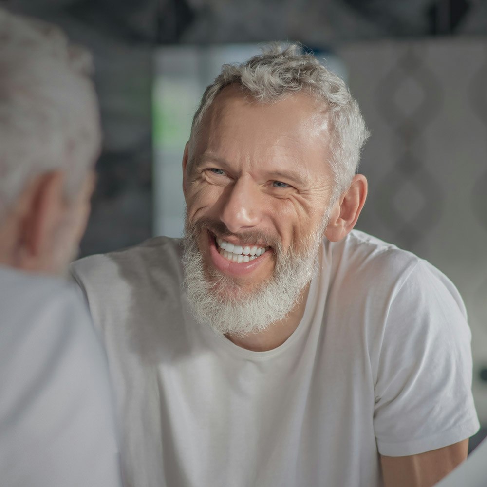 Man smiling in mirror
