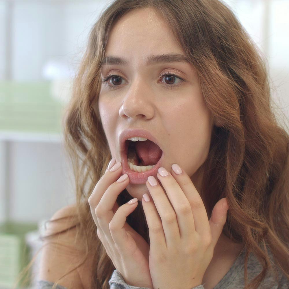 Concerned woman checking her teeth