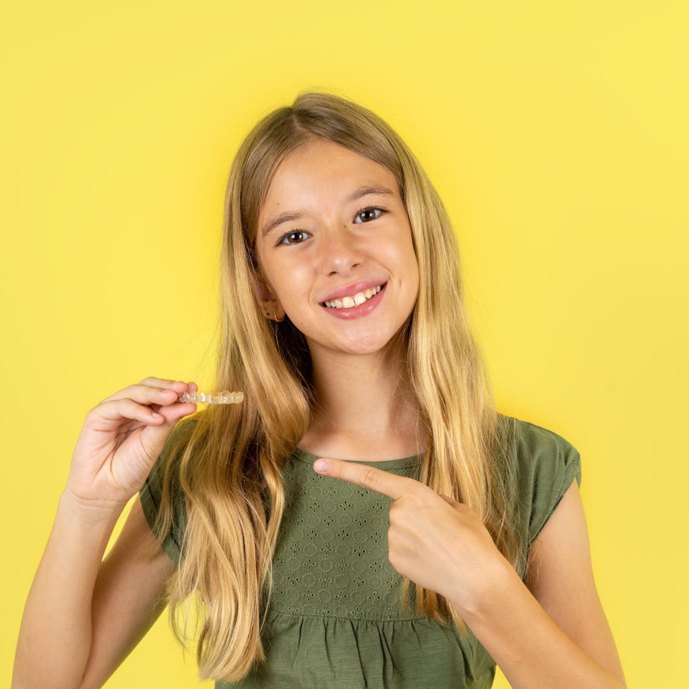 Invisalign aligner fitting over teeth