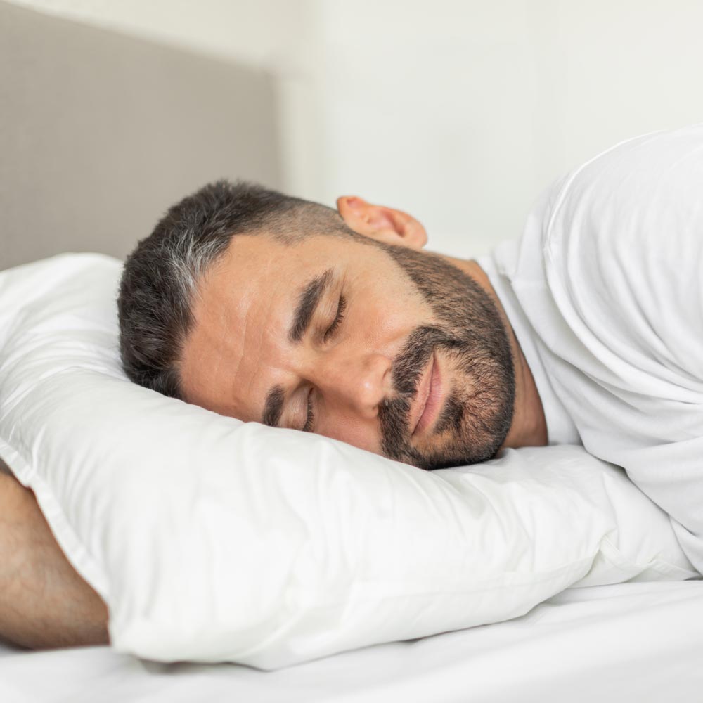 Man lying awake in bed