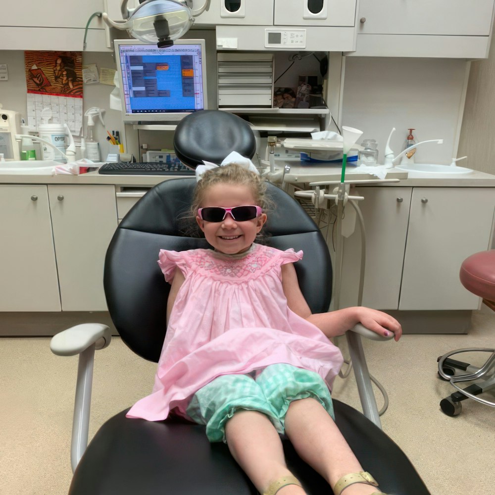 Smiling girl in the dental exam chair