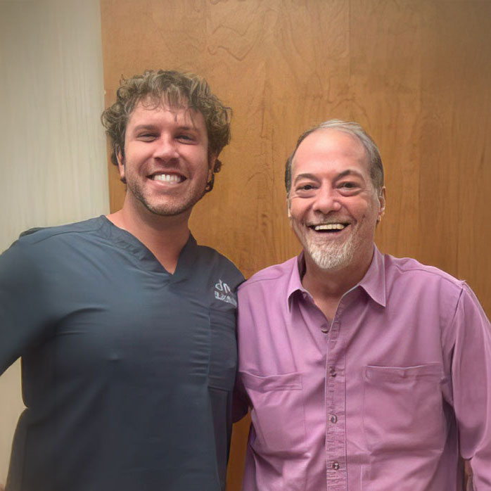 Dr. Measell posing with a smiling patient
