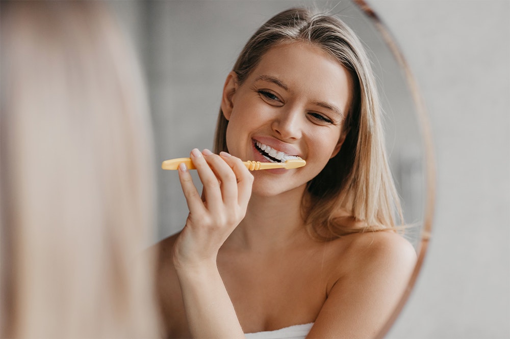 woman brushing teeth