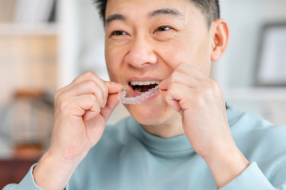 Man putting in Invisalign tray