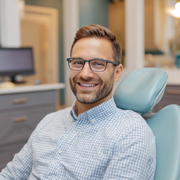 man smiling in the dental chair