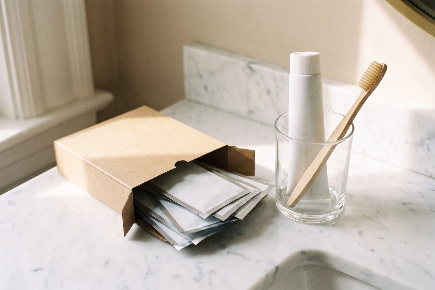 Over-the-counter whitening strips and whitening toothpaste on a bathroom counter