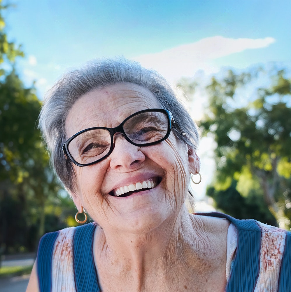 a smiling elderly woman with dental implants