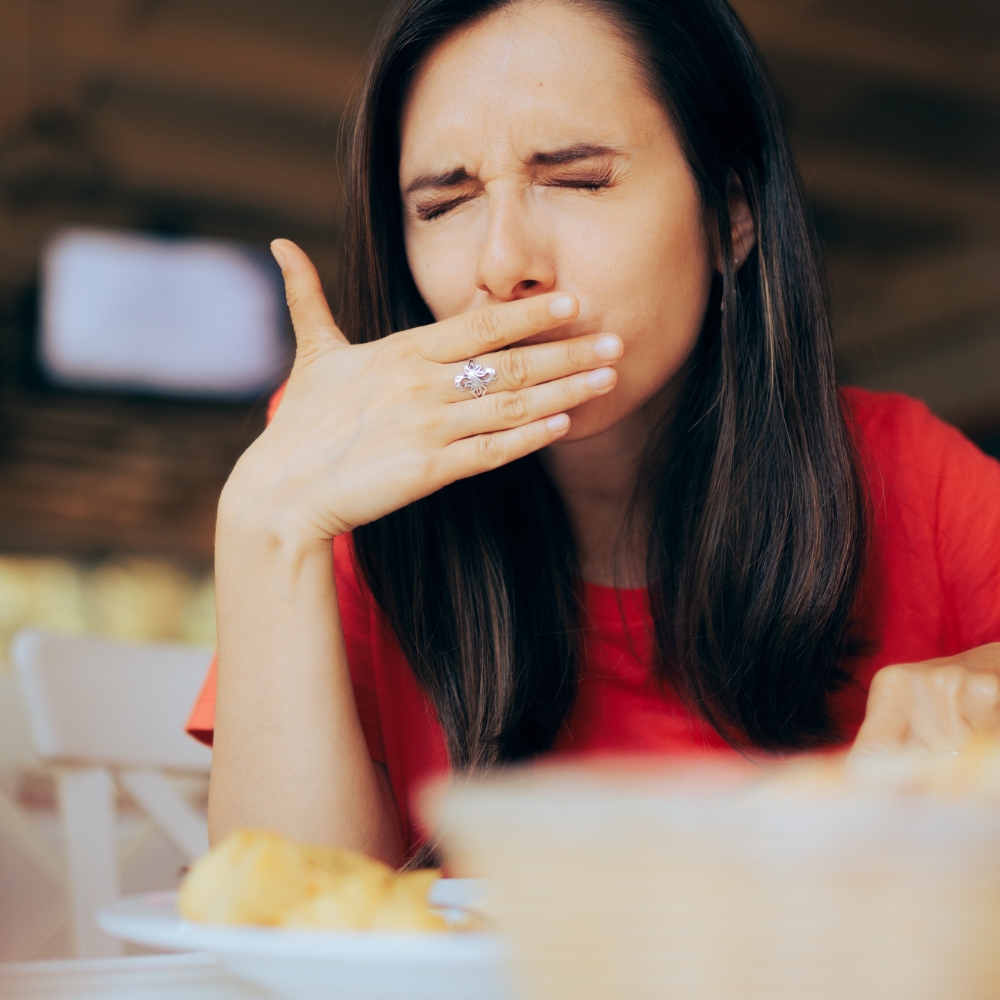 woman with veneers experiencing pain while biting food