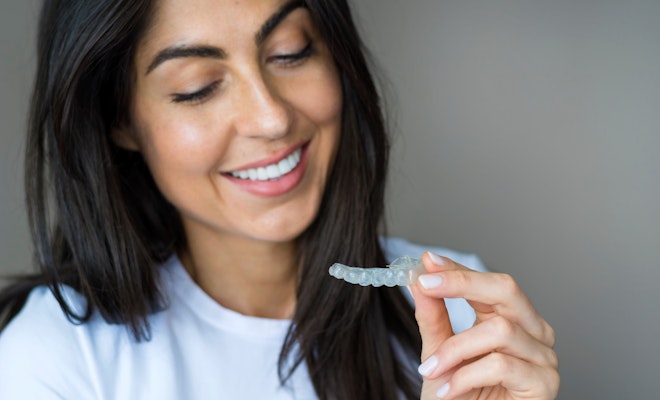 Woman looking at a clear aligner
