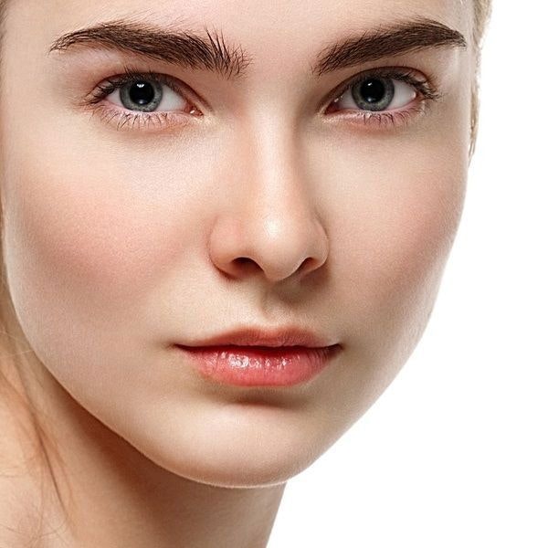 close up image of woman's face: fair skin, blue eyes