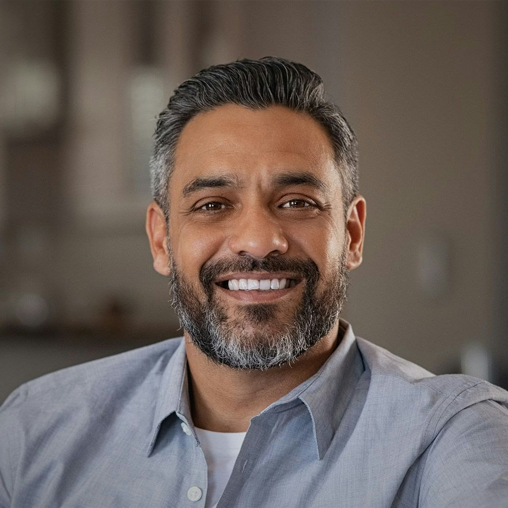 Smiling man with salt and pepper beard