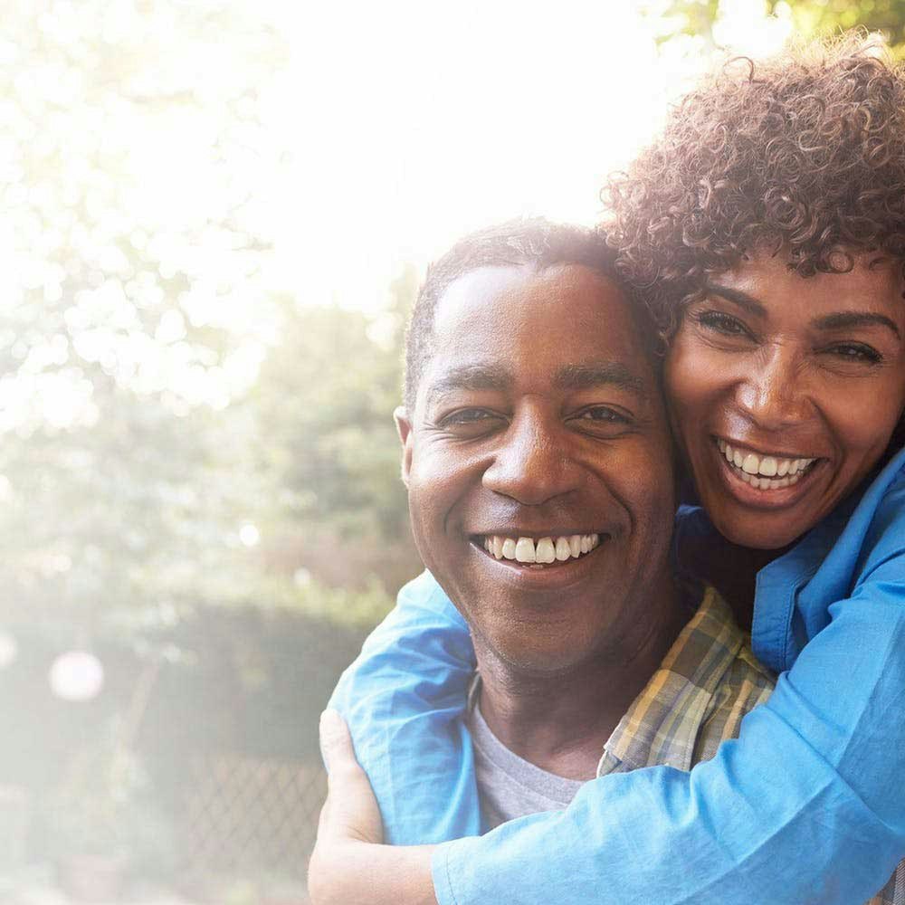 Woman hugging her partner from behind