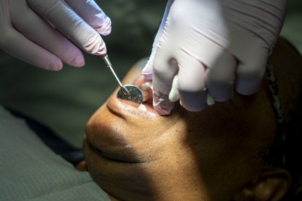 Patient under sedation getting teeth checked