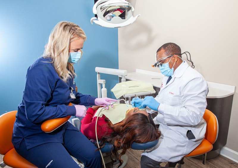 Dr. Saccoh and hygienist with patient