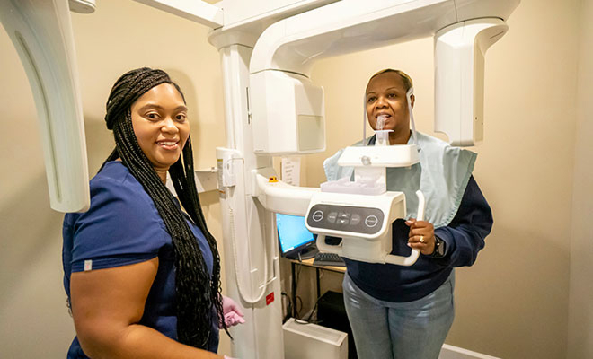 Staff with patient and cone beam scanner