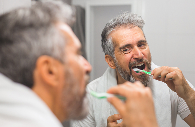 man brushing his teeth