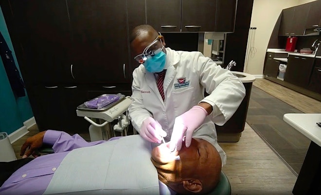 Dr. Saccoh working on patient