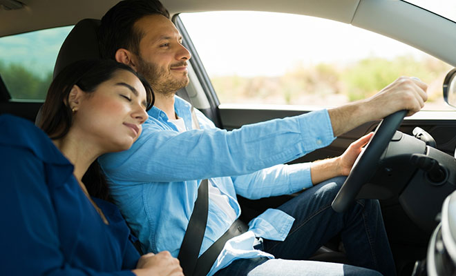 Husband driving his sleeping wife home