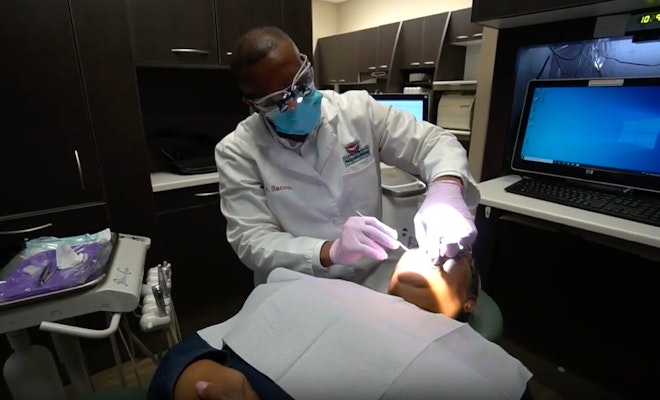 Dr. Saccoh working on patient