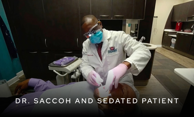 Dr. Saccoh working on patient