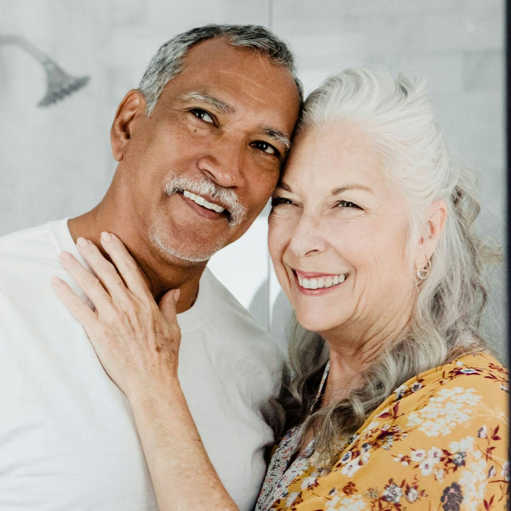 Smiling couple looking in the mirror