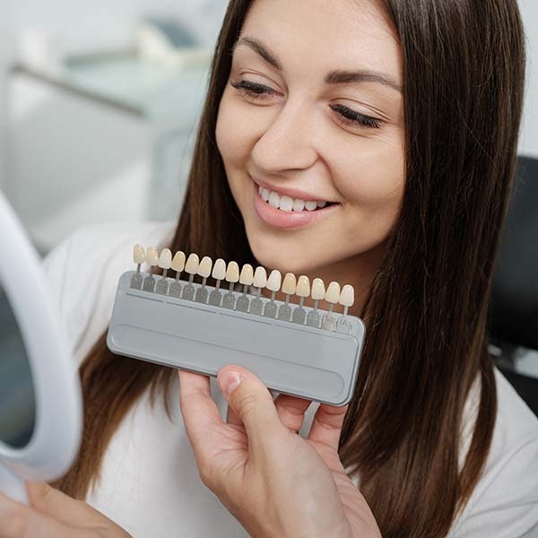 Woman being shade matched for veneers