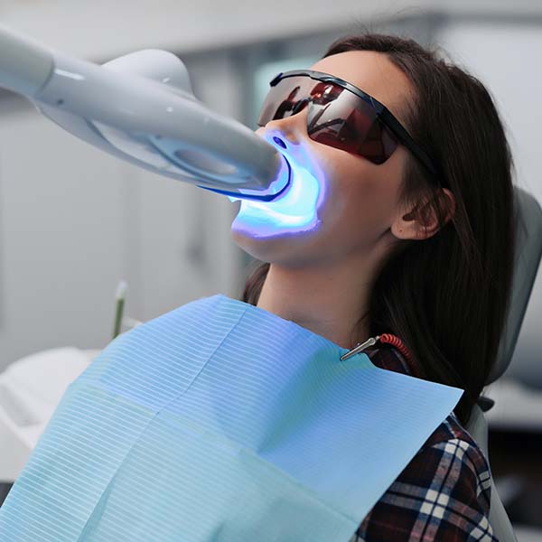 Woman undergoing laser teeth whitening