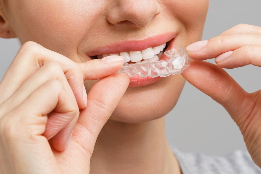 woman putting in whitening tray