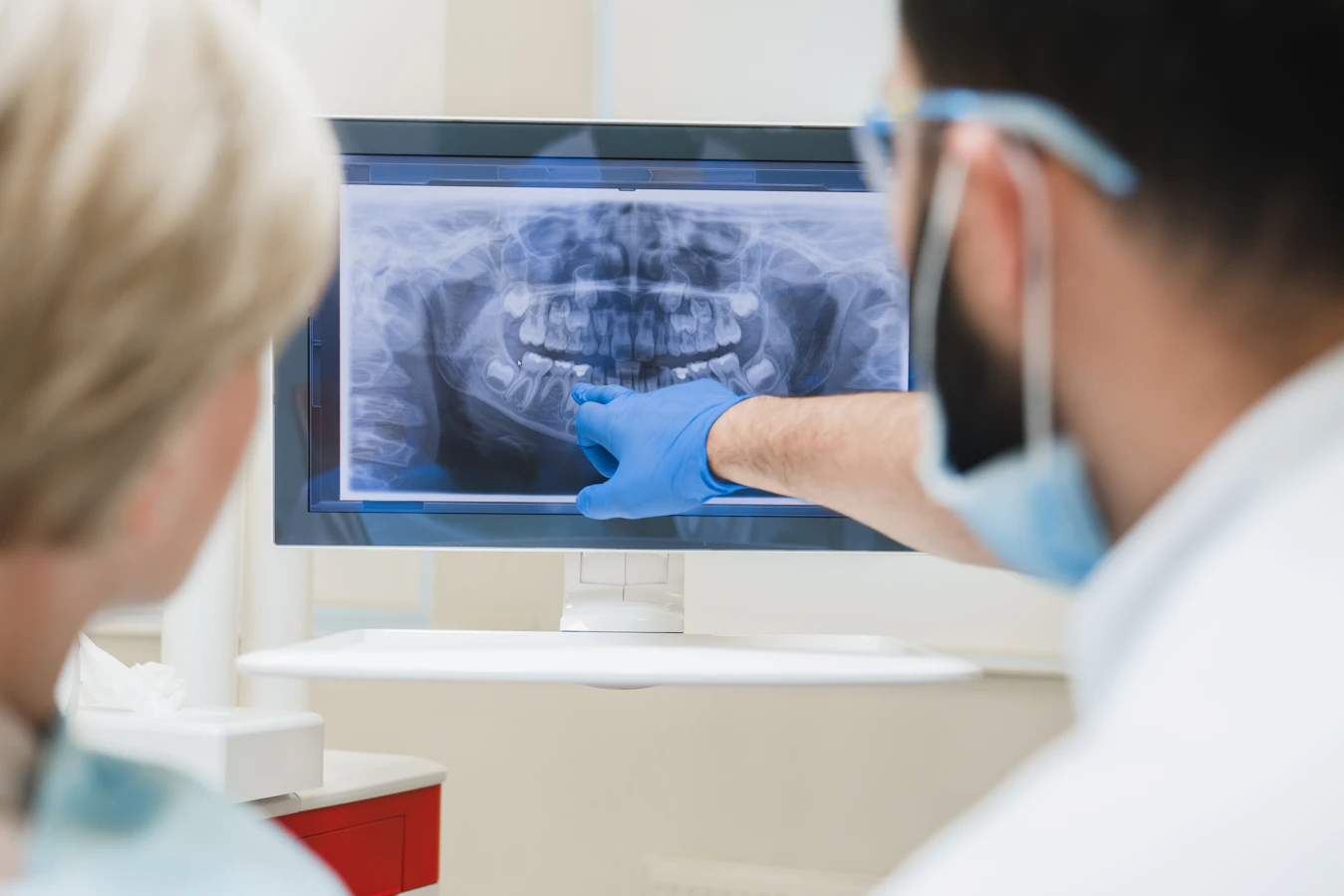 dentist examining x-ray