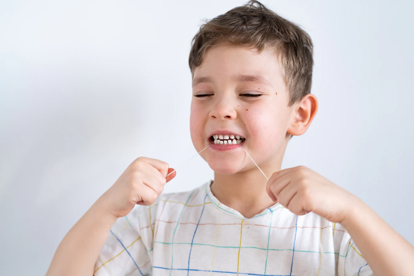 child using dental floss