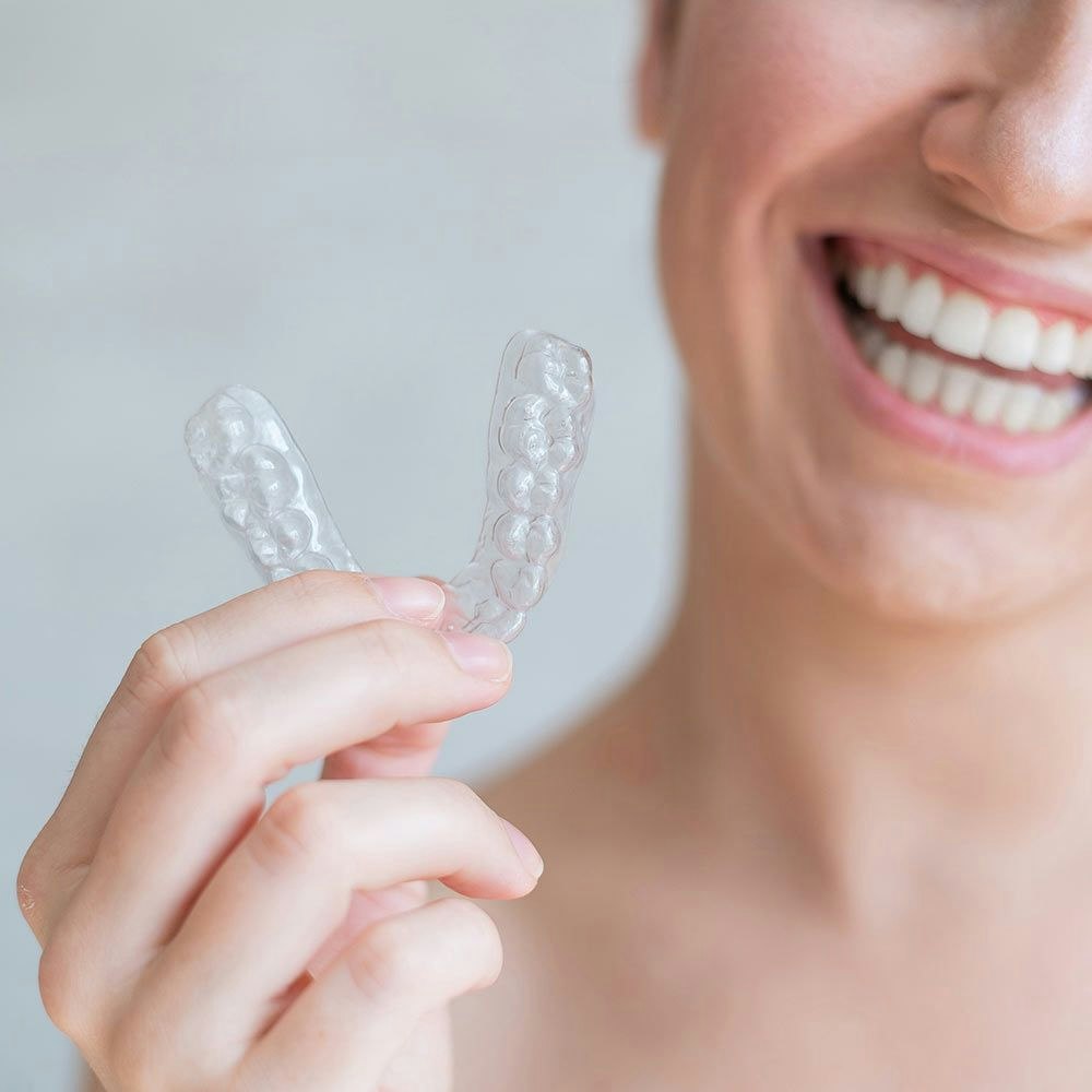 Woman holding invisalign